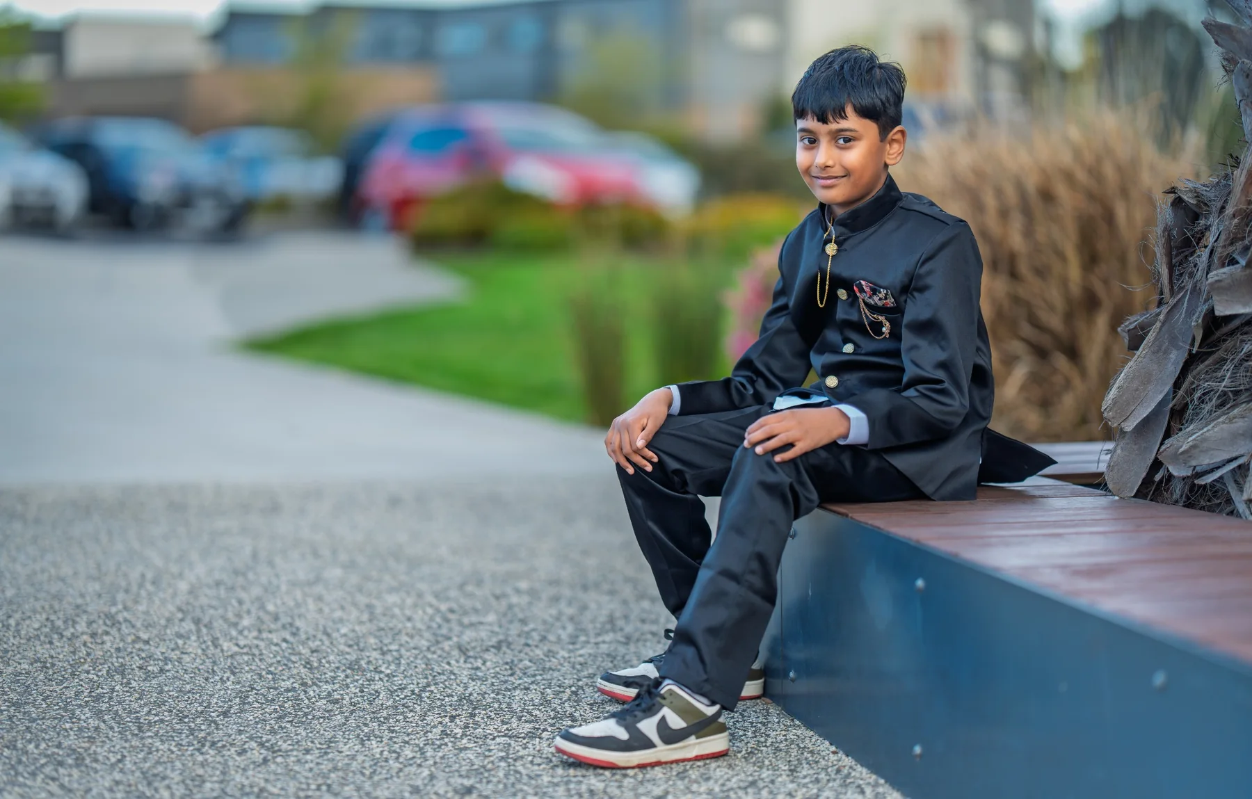 Young boy in formal clothing photographed outdoors in natural light