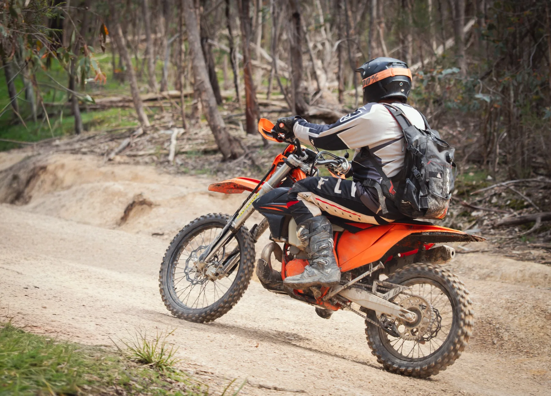 Off-road motorcycle rider photographed in action on a forest trail