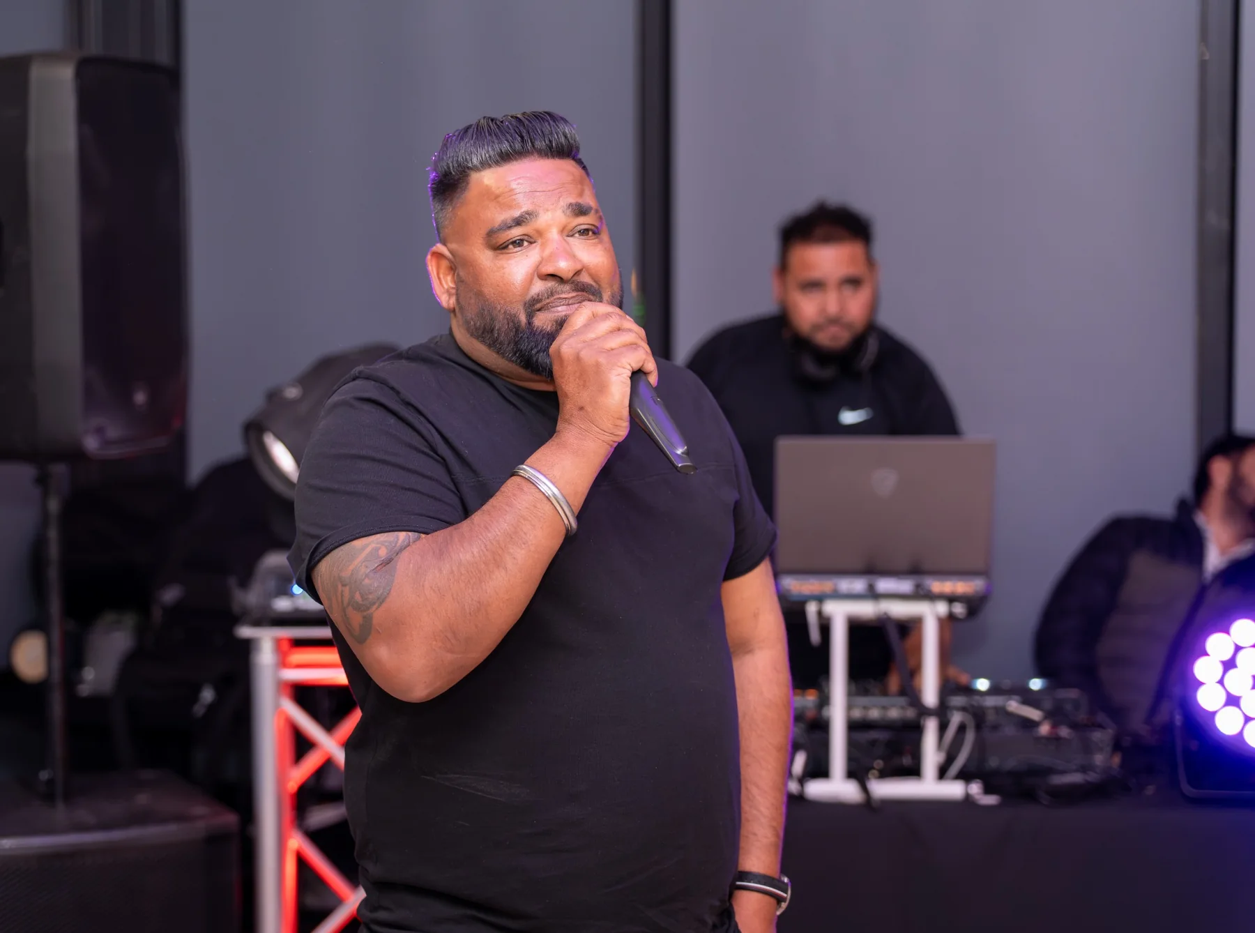 Live performer photographed on stage during an indoor event