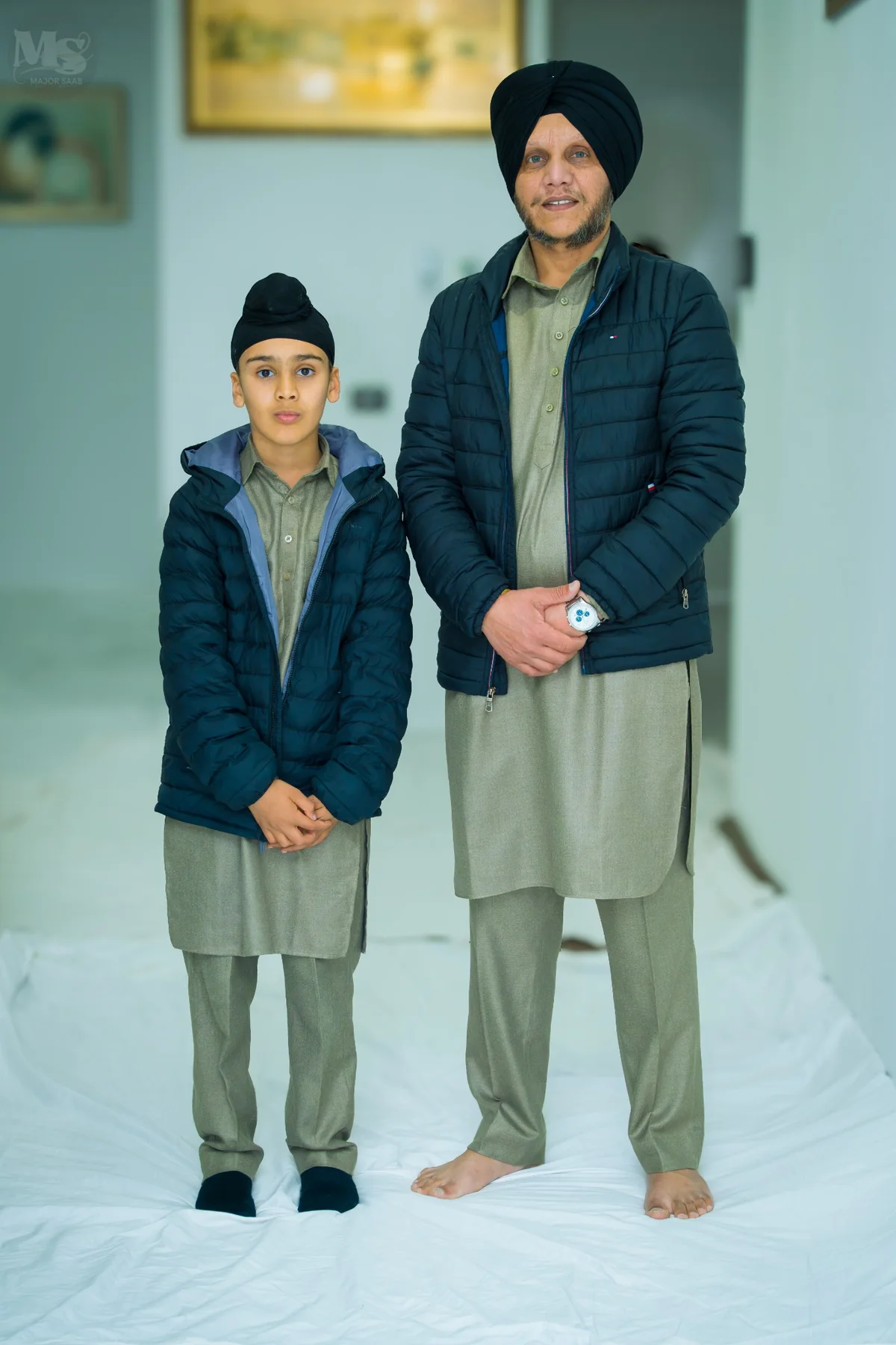 Family portrait of a father and son during a Punjabi celebration